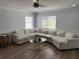 Bright living room with large wrap-around sofa, neutral color palette, and great natural light at 1505 Chevington Ct, Orlando, FL 32824