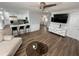 Bright open-concept living room featuring a kitchen bar, stylish furniture and wood-look flooring at 1505 Chevington Ct, Orlando, FL 32824