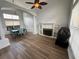 Living Room with fireplace and built-in bookshelves, plus a dining table with blue velvet chairs at 1505 Chevington Ct, Orlando, FL 32824