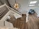 Bright foyer boasts a modern light fixture, staircase, and dining space with wainscoting details at 1505 Chevington Ct, Orlando, FL 32824