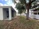 Spacious backyard featuring a large tree and a white vinyl fence for added privacy at 15408 Groose Point Ln, Clermont, FL 34714