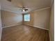 Bright bedroom with neutral walls, ceiling fan, and base molding at 15408 Groose Point Ln, Clermont, FL 34714