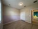 Spacious bedroom featuring vinyl floors, closet, and accent wall detail at 15408 Groose Point Ln, Clermont, FL 34714