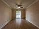 Large bedroom with ceiling fan and a sliding glass door leading to the outside at 15408 Groose Point Ln, Clermont, FL 34714