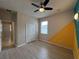 Bright bedroom featuring a ceiling fan, closet, and playful wall accents at 15408 Groose Point Ln, Clermont, FL 34714