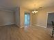 Bright dining area with modern light fixture and sliding glass doors leading to the backyard at 15408 Groose Point Ln, Clermont, FL 34714