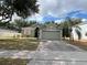 Charming one-story home featuring a brick driveway, a two-car garage, and a well-manicured lawn at 15408 Groose Point Ln, Clermont, FL 34714