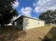Exterior side view of the home showcasing the yard and well-kept landscaping at 15408 Groose Point Ln, Clermont, FL 34714