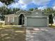 Charming single-story home featuring a two-car garage and nicely landscaped front yard at 15408 Groose Point Ln, Clermont, FL 34714