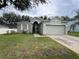 Inviting single-story home with a two car garage and well-maintained lawn with mulch at 15408 Groose Point Ln, Clermont, FL 34714