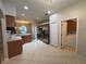 Kitchen with stainless steel appliances and an adjacent laundry room at 15408 Groose Point Ln, Clermont, FL 34714
