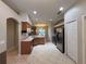 Open kitchen with stainless steel appliances and access to the dining room at 15408 Groose Point Ln, Clermont, FL 34714