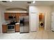 Kitchen with stainless steel appliances and access to the laundry room at 15408 Groose Point Ln, Clermont, FL 34714