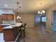 Kitchen sink, breakfast bar, and views to the dining and living areas at 15408 Groose Point Ln, Clermont, FL 34714