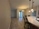 Open-concept living and dining area with modern pendant lighting and access to the outdoor patio at 15408 Groose Point Ln, Clermont, FL 34714