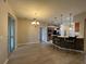 Living room with a chandelier, sliding glass door, and breakfast bar at 15408 Groose Point Ln, Clermont, FL 34714
