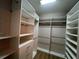 Spacious walk-in closet features ample shelving and hanging space for organization and storage at 15408 Groose Point Ln, Clermont, FL 34714