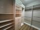 Walk-in closet with custom shelving and hanging rods to maximize storage space at 15408 Groose Point Ln, Clermont, FL 34714
