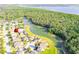 Beautiful aerial view of a residential area with lush green trees and a serene lake at 156 Bristol Forest Trl, Sanford, FL 32771