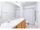 Bright bathroom featuring double sinks, a large mirror, and a shower with a patterned curtain at 156 Bristol Forest Trl, Sanford, FL 32771