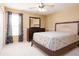 This bedroom has a ceiling fan, dresser, and a bright window at 156 Bristol Forest Trl, Sanford, FL 32771