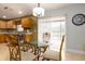 A dining area with a glass-top table and chairs, adjacent to the kitchen and overlooking the pool area at 156 Bristol Forest Trl, Sanford, FL 32771