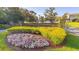 Landscaped community entrance with colorful flower beds and shrubbery at 156 Bristol Forest Trl, Sanford, FL 32771
