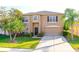 Charming two-story home with a well-manicured lawn, lush landscaping, and a welcoming front entrance at 156 Bristol Forest Trl, Sanford, FL 32771