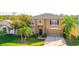 Charming two-story home with a well-manicured lawn, lush landscaping, and a welcoming front entrance at 156 Bristol Forest Trl, Sanford, FL 32771