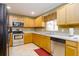 Well-lit kitchen with stainless steel appliances and wood cabinetry at 156 Bristol Forest Trl, Sanford, FL 32771
