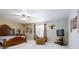 This spacious bedroom features a ceiling fan, recliner, and large window at 156 Bristol Forest Trl, Sanford, FL 32771