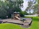 Community playground with various play structures, a picnic table, and a swing set at 156 Bristol Forest Trl, Sanford, FL 32771