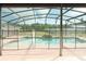 Inviting pool area enclosed with a screen, surrounded by lush greenery for privacy and relaxation at 156 Bristol Forest Trl, Sanford, FL 32771