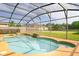 Sparkling pool surrounded by a screened enclosure, ideal for outdoor relaxation at 156 Bristol Forest Trl, Sanford, FL 32771