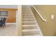 A carpeted stairway with white railings connects the floors within the home at 156 Bristol Forest Trl, Sanford, FL 32771