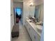 Bathroom boasting dual sinks with white cabinets and an elongated countertop at 15929 Moonlight Bay St, Winter Garden, FL 34787