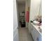 Bright bathroom with and sinks, white cabinets, white walls and white tile floors at 15929 Moonlight Bay St, Winter Garden, FL 34787