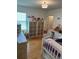 Bright bedroom with hardwood floors, neutral walls, closet, and lots of natural light at 15929 Moonlight Bay St, Winter Garden, FL 34787