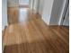 Bright hallway featuring hardwood floors, neutral walls, and white trim at 15929 Moonlight Bay St, Winter Garden, FL 34787