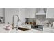 Bright kitchen showcases white cabinetry, stainless steel appliances, and an elegant backsplash at 15929 Moonlight Bay St, Winter Garden, FL 34787