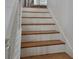 Stairway features wooden treads and white risers leading to the upper level at 15929 Moonlight Bay St, Winter Garden, FL 34787