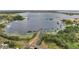 Expansive aerial view showcases a large lakefront property with lush greenery and multiple private docks at 1626 Salmon St, St Cloud, FL 34771
