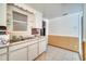 A kitchen with white cabinets, window, and tile floor that is in need of updating at 1626 Salmon St, St Cloud, FL 34771