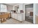 Dated kitchen featuring white cabinetry and a window, showing its potential at 1626 Salmon St, St Cloud, FL 34771