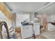 Laundry area with a washer, dryer and various discarded household items at 1626 Salmon St, St Cloud, FL 34771
