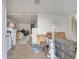 Untidy living room with debris, objects and worn-out wooden floor at 1626 Salmon St, St Cloud, FL 34771