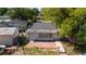 The backyard has a patio area, is surrounded by a chain link fence, and has mature trees at 1814 Leroy Dr, Haines City, FL 33844
