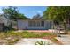 The backyard has a patio area, is surrounded by a chain link fence, and has mature trees at 1814 Leroy Dr, Haines City, FL 33844