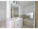 Bathroom featuring a large mirror, modern sink vanity, soaking tub, and separate shower at 1814 Leroy Dr, Haines City, FL 33844