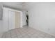 A bedroom with tile floors, white walls, and a ceiling fan at 1814 Leroy Dr, Haines City, FL 33844